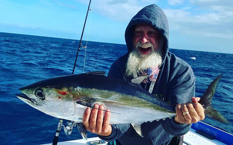 An image of an angler with a blackfin tuna aboard a charter with captian kevin grubb. 